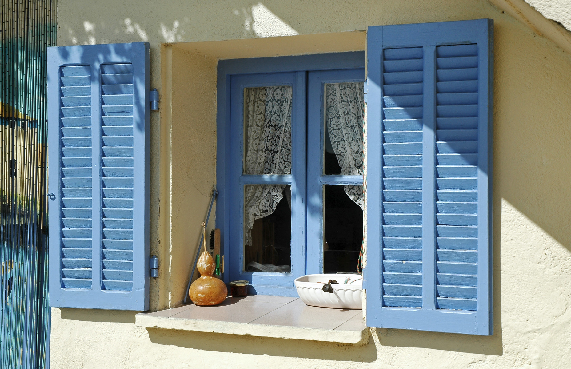 Opened blue window shutters